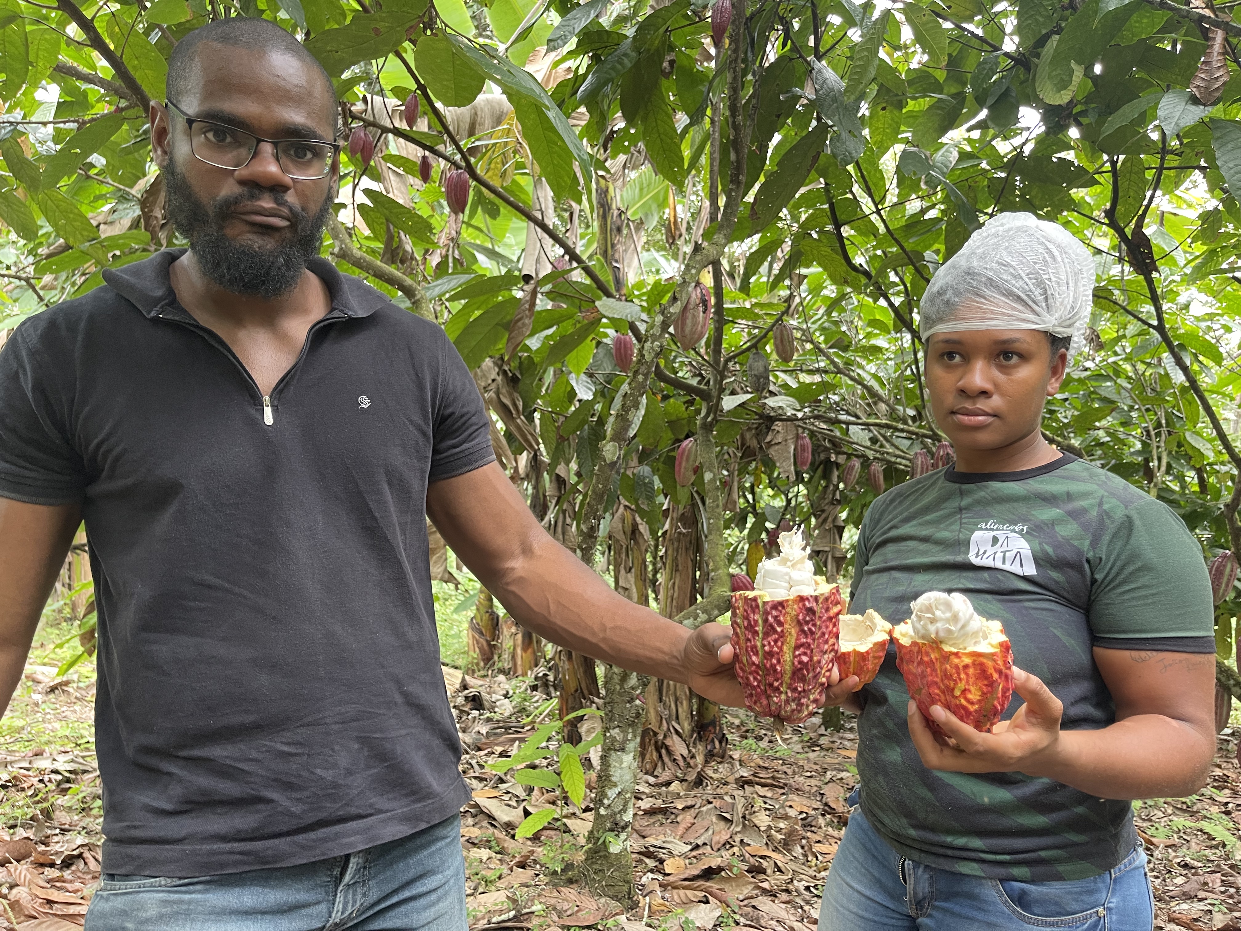 Matheus and Mailan at SĂŁo Jorge Farm holding cacao pods